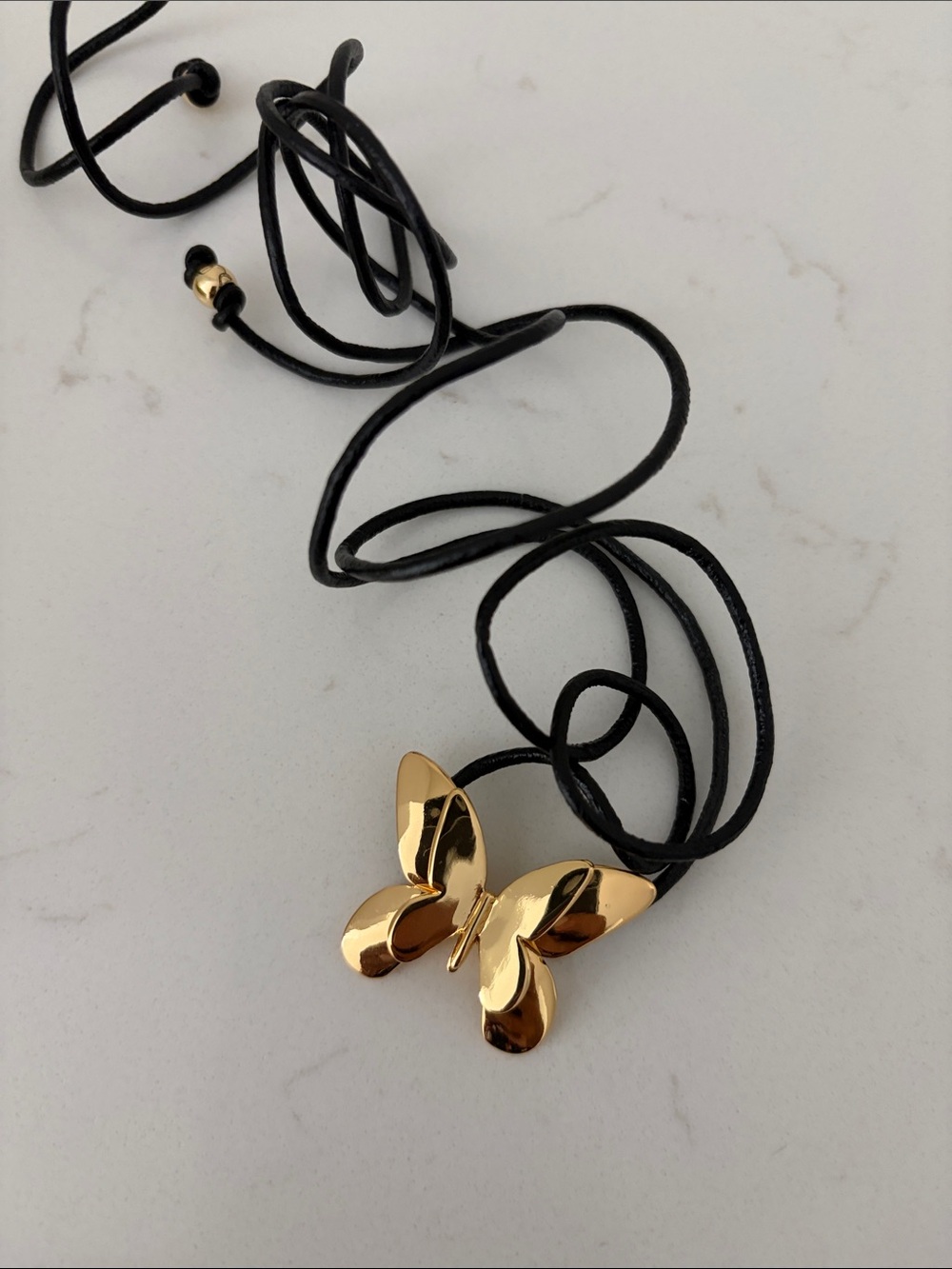 GOLD BUTTERFLY ON CORD NECKLACE